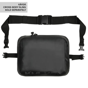 A black cross-body sling bag with an adjustable webbing strap and plastic buckle, shown on a white background with a text label in the top-left corner stating 'KÄYDÄ CROSS-BODY SLING SOLD SEPARATELY'.