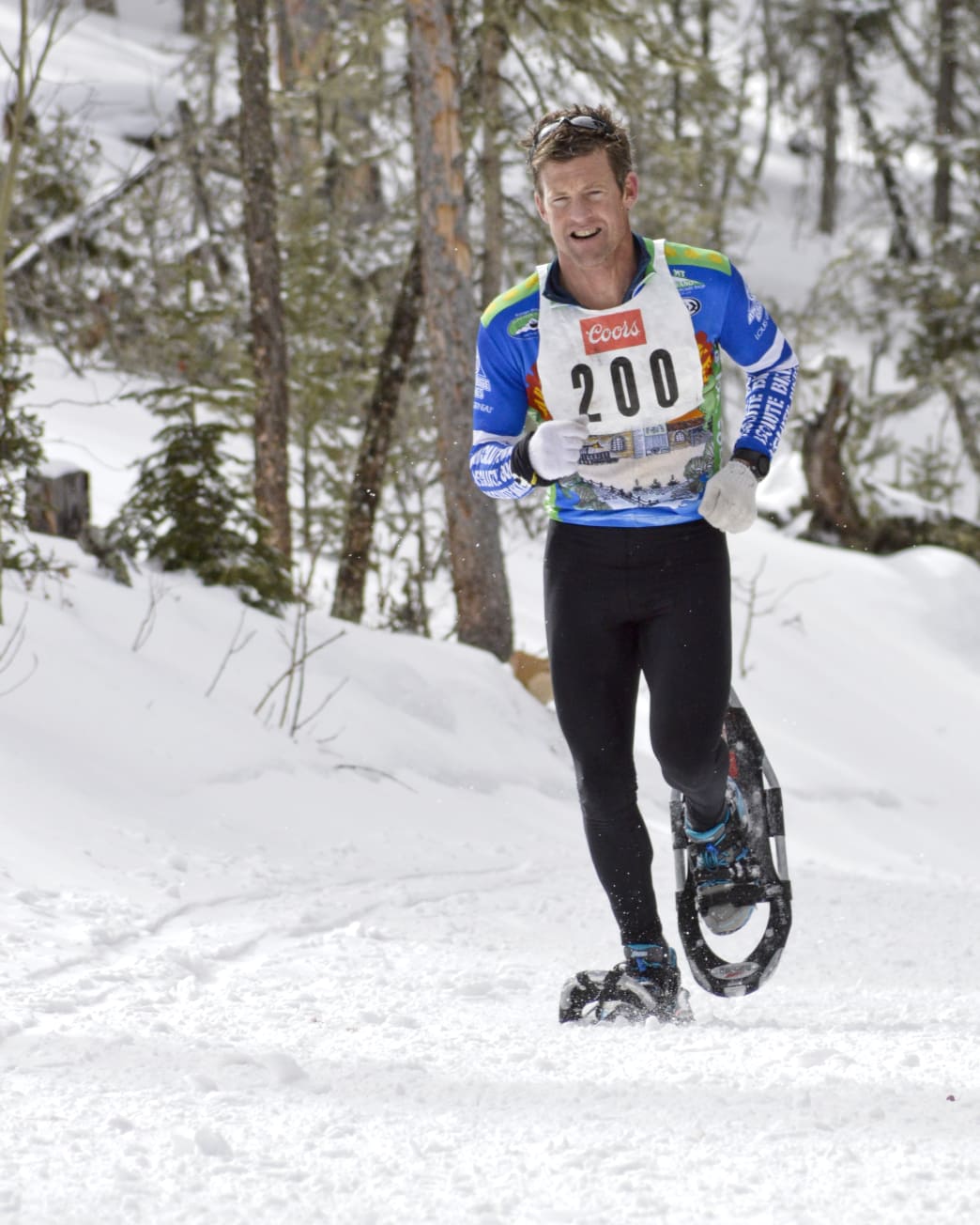 Man snowshoeing through trails