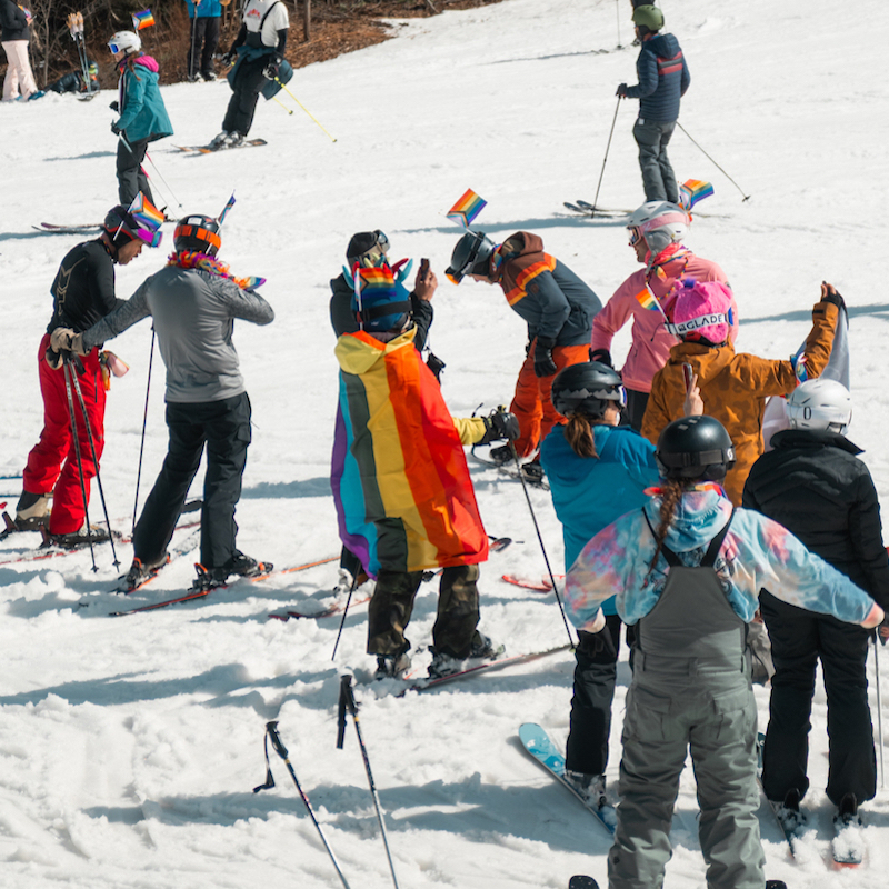 Group of skiers on sunny day skiing in spring