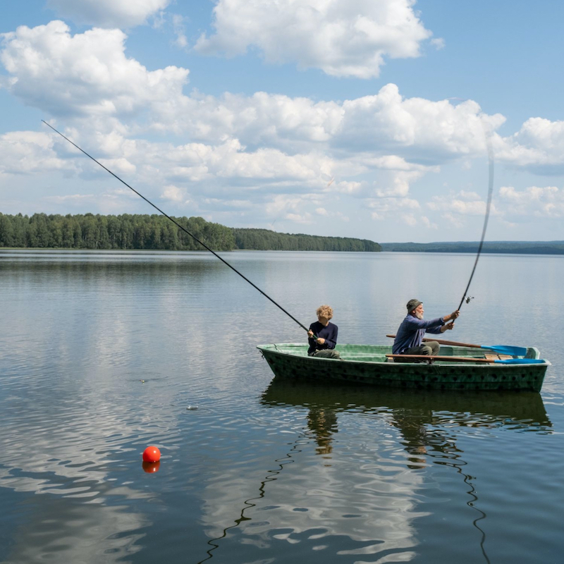 Father and son fishing in boat