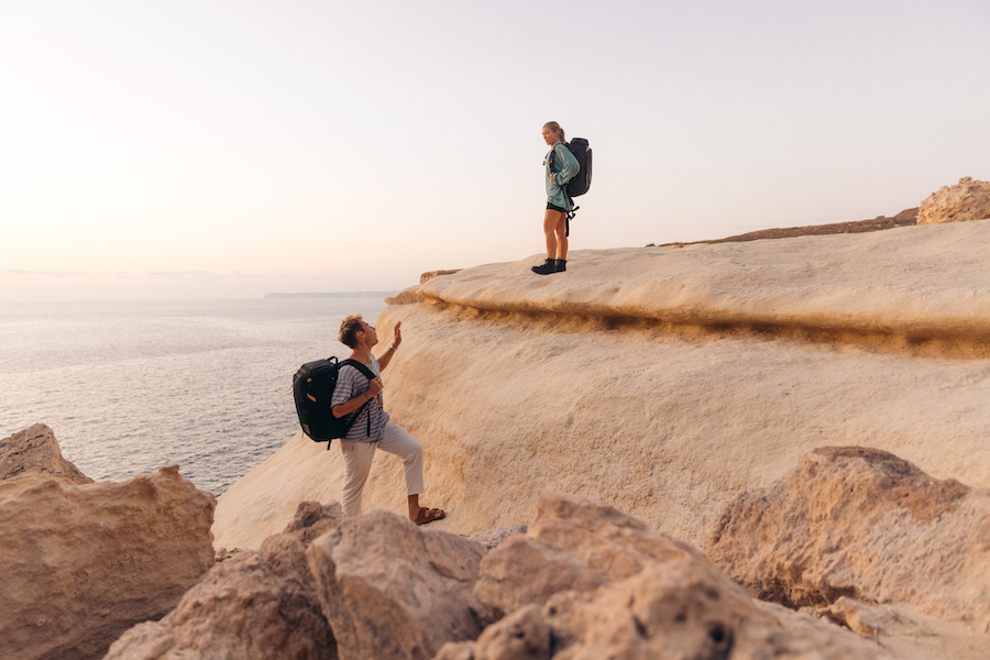 Male and female hikers wearing kulkea travel backpacks