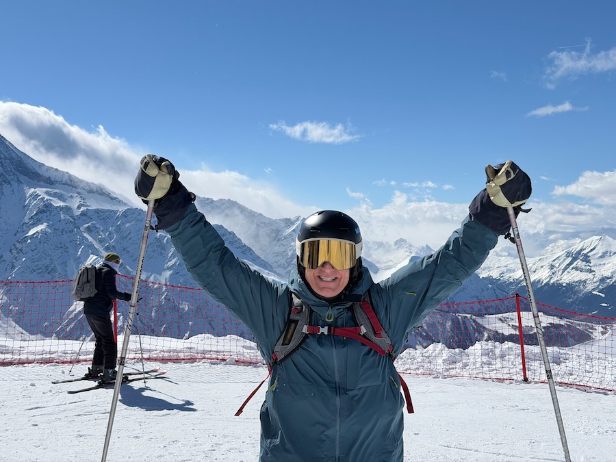 Male skier standing on mountain with kulkea gear