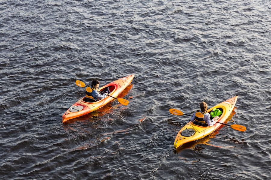 Two adults kayaking on a lake