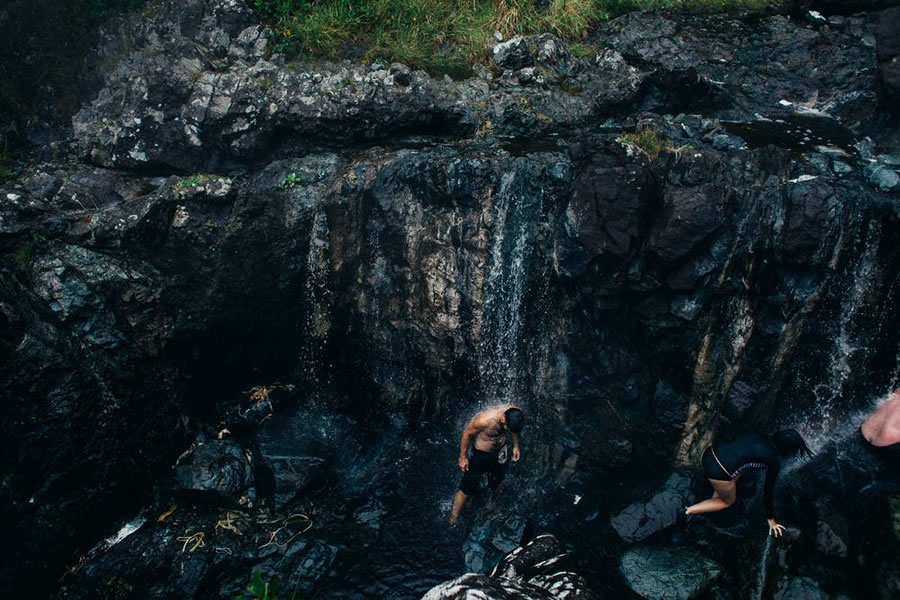 Connecting with nature under a waterfall