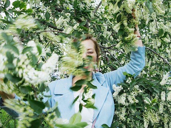 woman emerging from tree branches