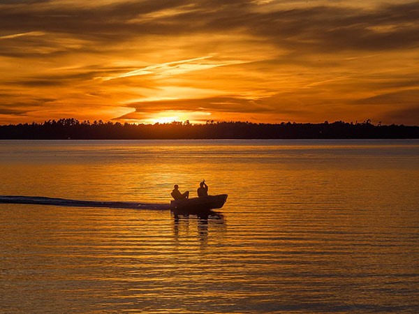 boat on a lake at sunset